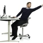 Sitting_in_a_HÅG_Capisco_working_at_a_height-adjustable_work_desk